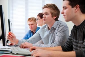 Group of students attending training course in a computer classroom